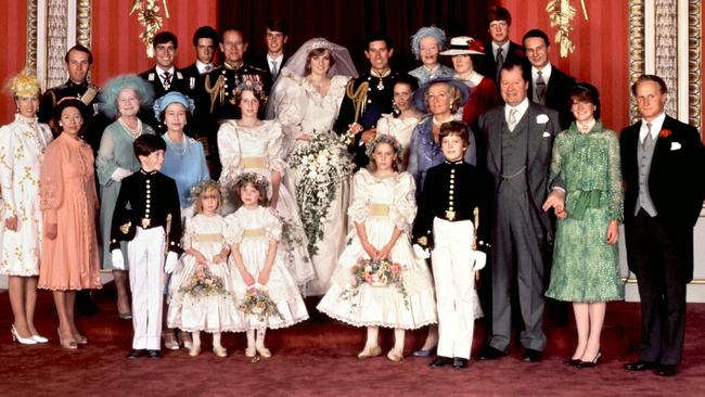 Lord Robert Fellowes (back row, far right) is pictured at the then Prince Charles and Princess Diana’s wedding day in 1981. Picture: AFP