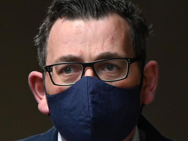 Victoria's state premier Daniel Andrews wears a mask as he arrives at a press conference in Melbourne on July 22, 2020. - Australia reported a record 501 new COVID-19 coronavirus infections on July 22, nearly four months after the pandemic initially peaked in the country, with authorities warning of a critical new phase in its two biggest cities. (Photo by William WEST / AFP)