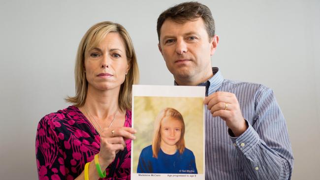 Kate and Gerry McCann pose with an artist's impression of how their missing daughter Madeleine might have looked at the age of nine. Picture: Leon Neal.