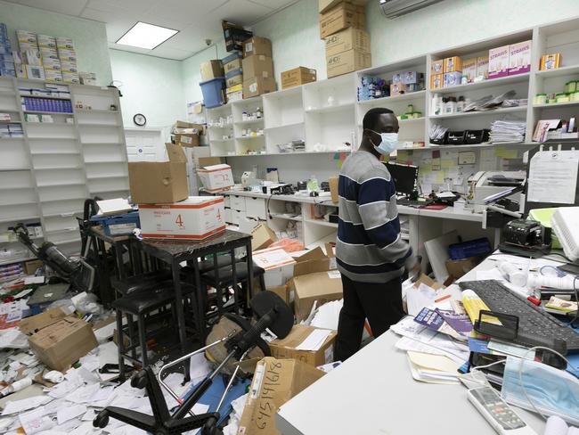 Foster Akuoko, the owner of Planet Pharmacy, looks around his ransacked store in the Bronx. Picture: AP