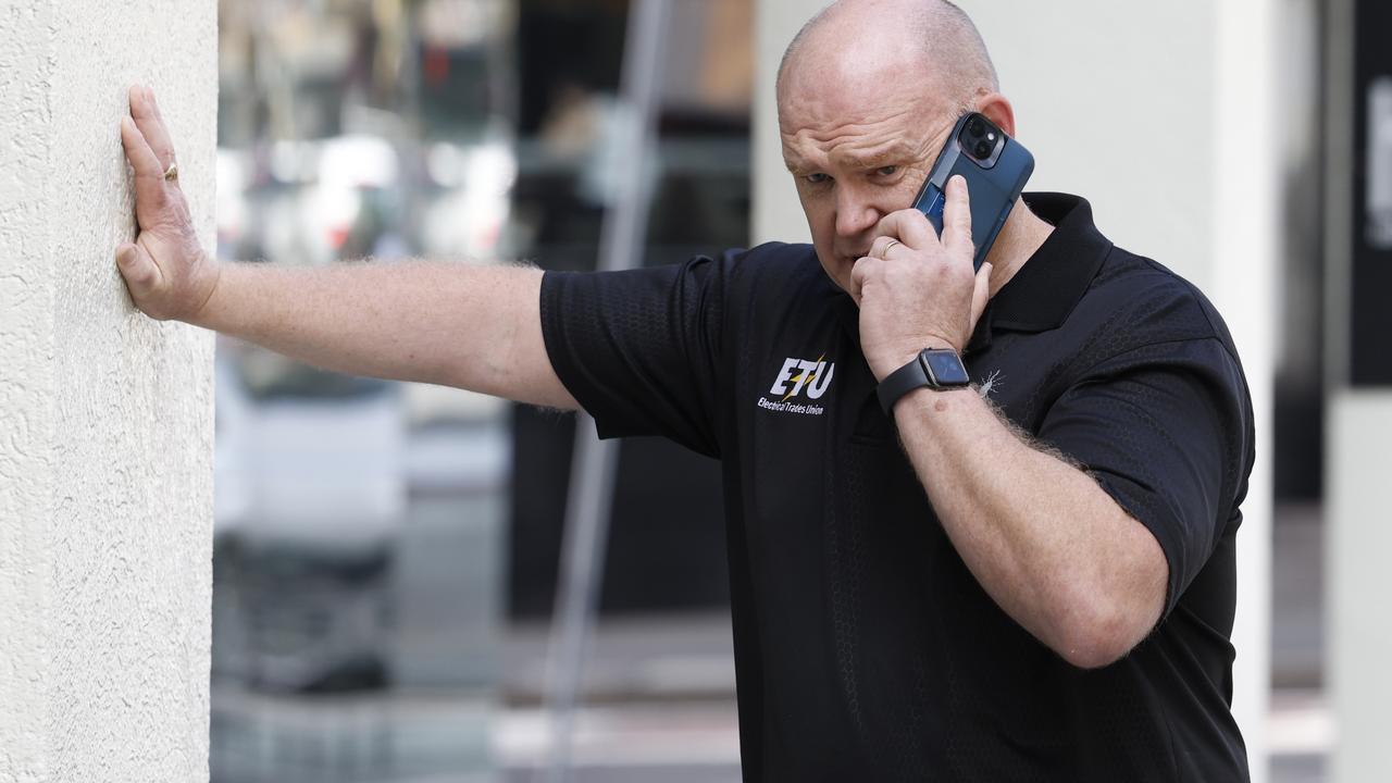 Allen Hicks takes a call outside the Fair Work Commission on William Street in Sydney. Picture: Richard Dobson