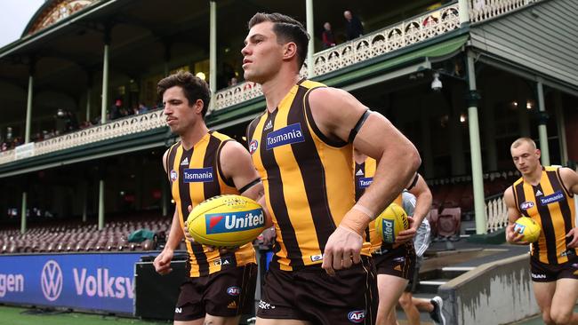 Jaeger O’Meara leads Hawthorn onto the SCG alongside current captain Ben Stratton. Picture: Getty