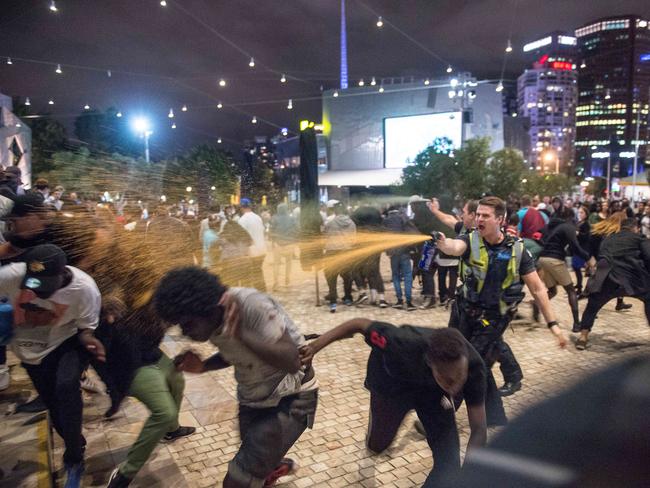 Police subdue groups of young men in Federation Square on Saturday. Picture: Jake Nowakowski