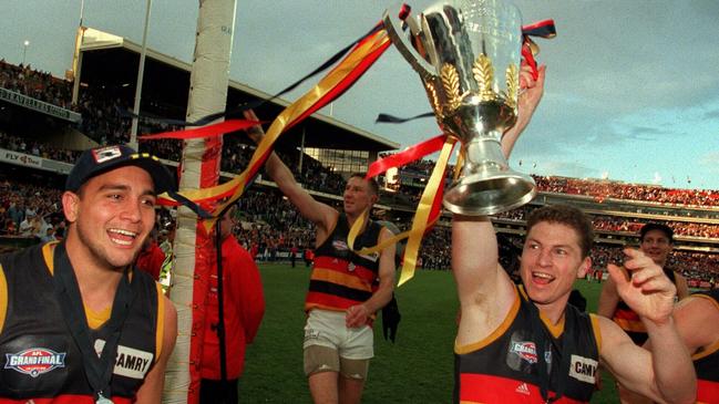 Adelaide Crows  Andrew McLeod celebrating with Mark Bickley holding premiership cup after beating North Melbourne in 1998 grand final.