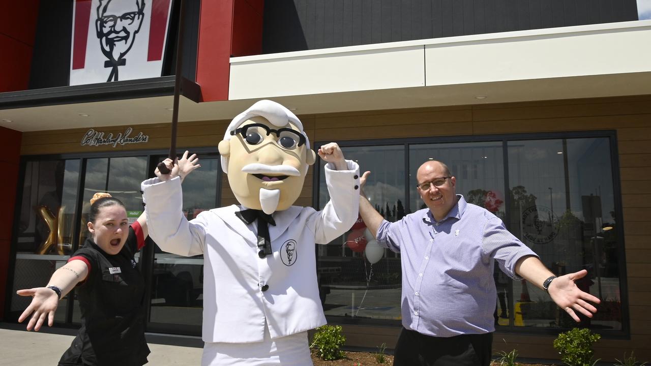 KFC opens in Highfields. KFC mascot, Colonel Sanders, with store manager Amber Harding-Dolan and area manager Trent Brigginshaw.