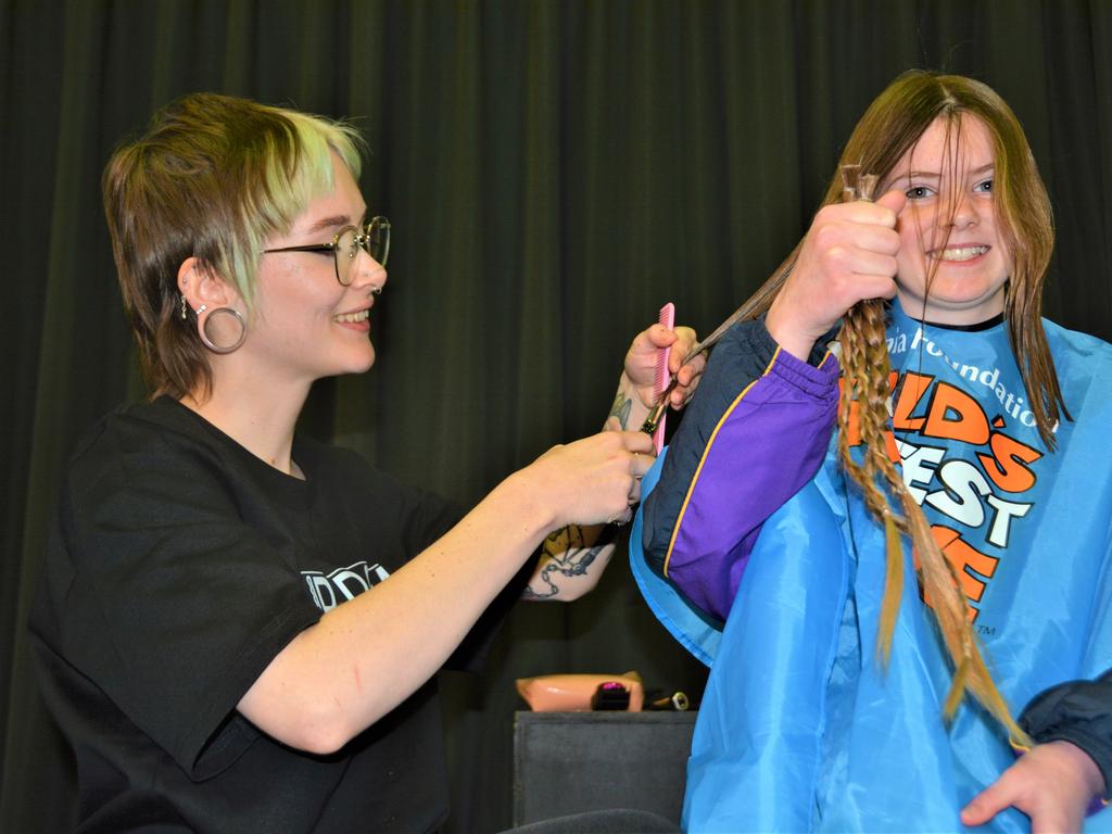 At the St Joseph's College 2023 World's Greatest Shave event is student Charlotte Fleming having her cut by hairdresser Caitlin Symes from the Hair Room on Russell. Picture: Rhylea Millar