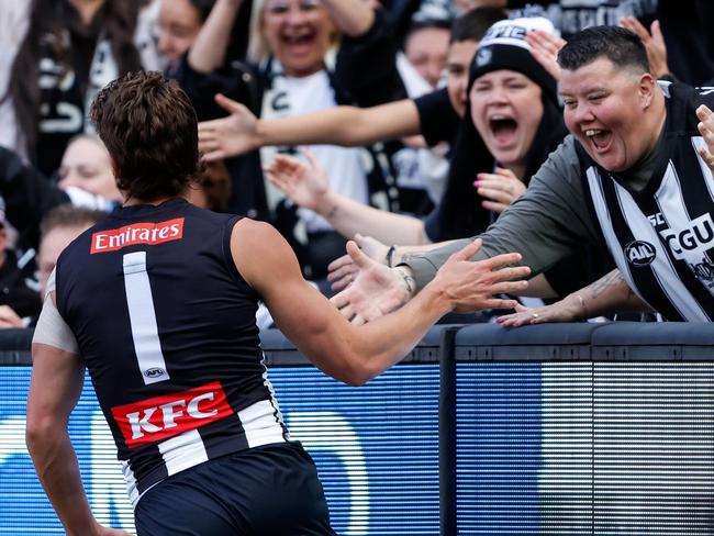 MELBOURNE, AUSTRALIA – APRIL 20: Patrick Lipinski of the Magpies celebrates a goal with the crowd during the 2024 AFL Round 06 match between the Collingwood Magpies and the Port Adelaide Power at the Melbourne Cricket Ground on April 20, 2024 in Melbourne, Australia. (Photo by Dylan Burns/AFL Photos via Getty Images)