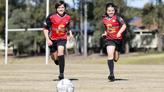 Bonora siblings Dylan and Lilly are keen for people to get vaccinated so they can get back to playing soccer. Picture: Tim Hunter