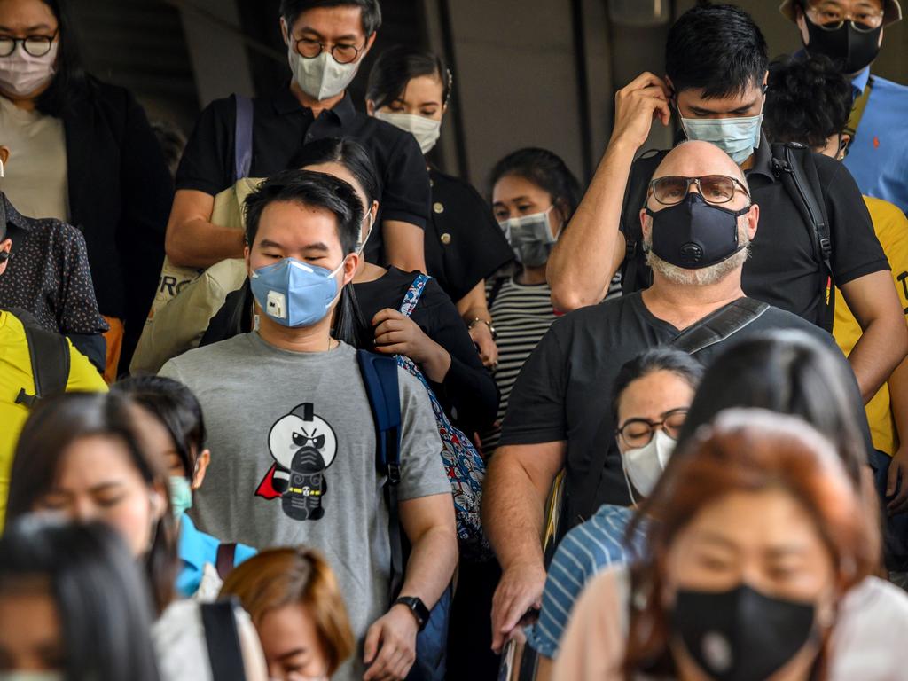 People wearing protective face masks leave the city commuter train station in Bangkok, where Chinese holiday-makers typically spend around $18 billion nationally. Picture: Mladen Antonov / AFP