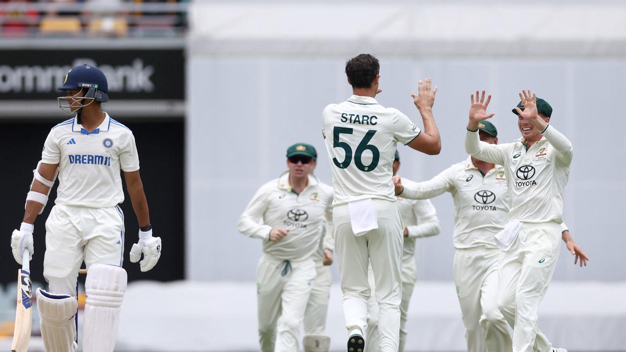 The Aussies celebrate as Jaiswal walks off. (Photo by David GRAY / AFP)