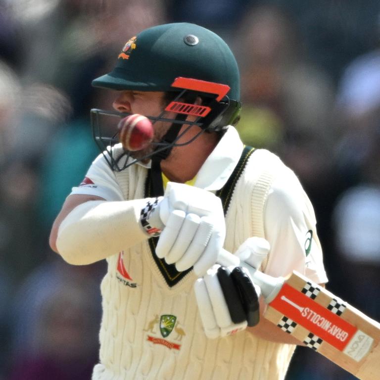 Travis Head of Australia is hit on the helmet by a ball delivered by Mark Wood. (Photo by Stu Forster/Getty Images)