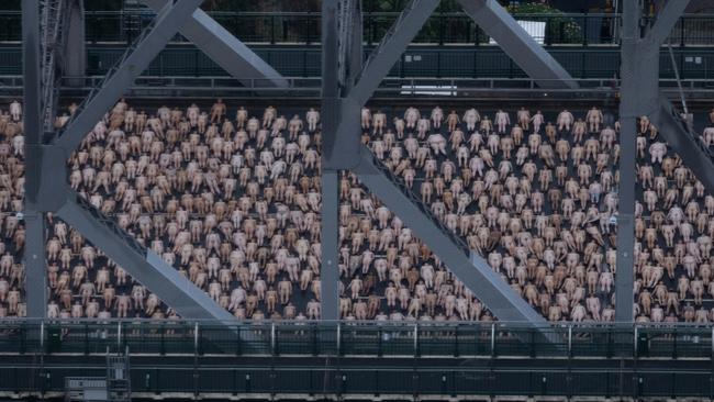 Nude men and women gather for New York artist Spencer Tunick’s Story Bridge work. Picture: NewsWire/ David Kapernick