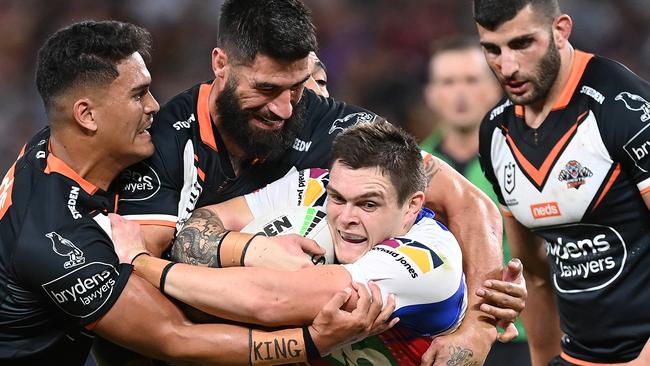 BRISBANE, AUSTRALIA - MAY 14:  Brodie Jones of the Knights is tackled during the round 10 NRL match between the Wests Tigers and the Newcastle Knights at Suncorp Stadium on May 14, 2021, in Brisbane, Australia. (Photo by Bradley Kanaris/Getty Images)