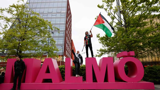 A pro-Palestinian protester with a Palestinian flag demonstrates at Hyllie arena square ahead of the second semi-final of the Eurovision Song Contest in Malmo. Picture: AFP.