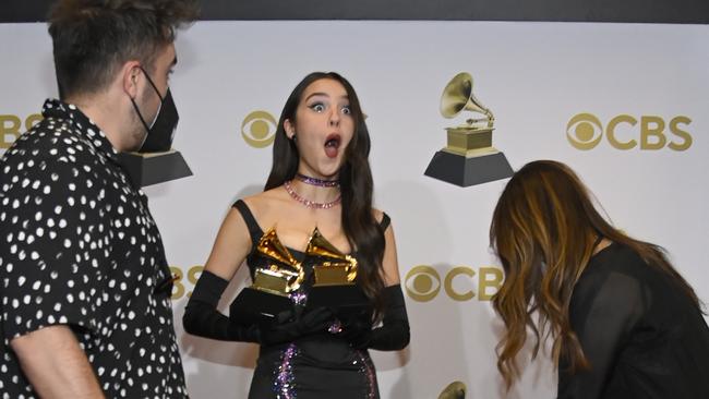 Olivia Rodrigo breaks one of her Grammys backstage. Picture: Getty Images