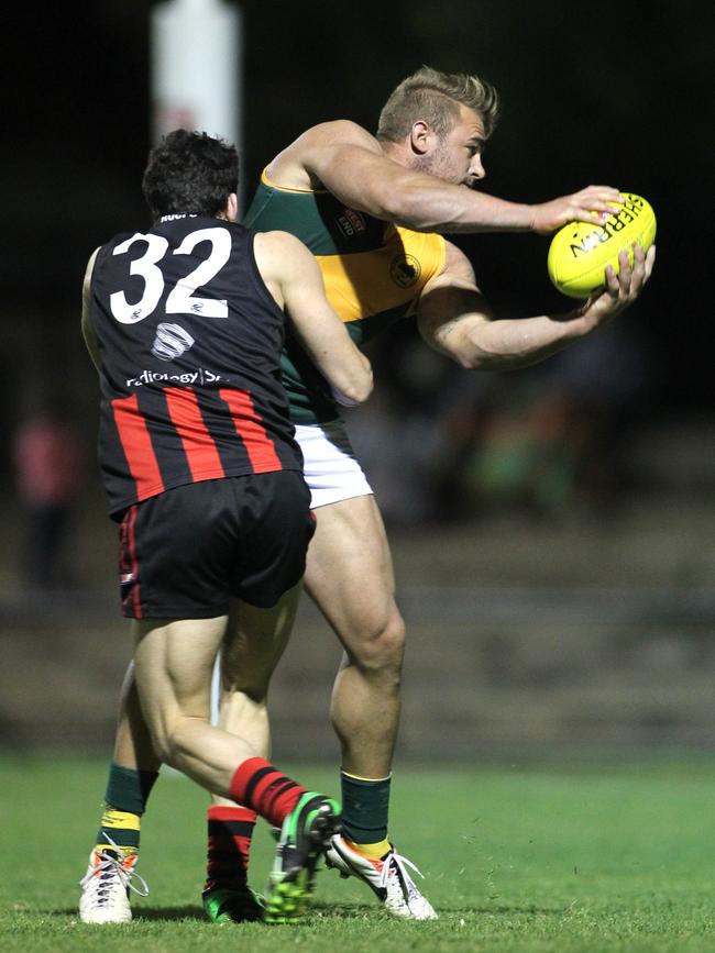 Callum Hay is tackled during the division one grand final replay against Rostrevor Old Collegians in 2013. Picture: Stephen Laffer.