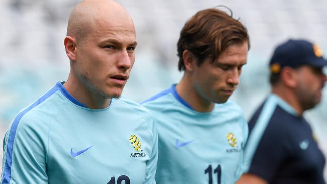 Socceroos midfielder Aaron Mooy, pictured left with Craig Goodwin, will start from the bench against Syria in Sydney tonight.