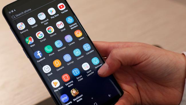 A man holds a Samsung S9+ mobilephone at the Mobile World Congress (MWC), the world's biggest mobile fair, on February 26, 2018 in Barcelona. The Mobile World Congress is held in Barcelona from February 26 to March 1. / AFP PHOTO / Pau Barrena