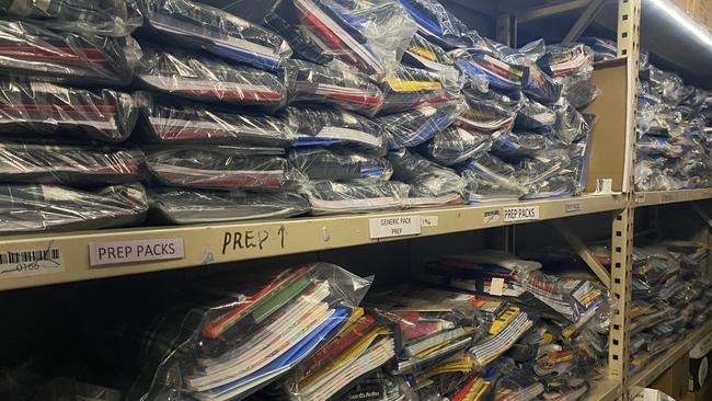 Packs upon packs of school books line the Zephyr garage walls, each tailored to the needs of individual year groups.