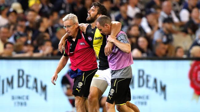 Richmond star Alex Rance is helped from the ground after rupturing his ACL against Carlton. Picture: Dylan Burns/AFL Photos/Getty Images