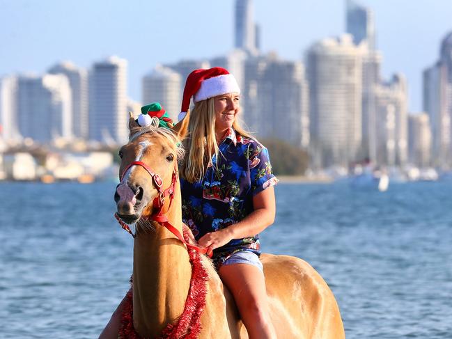 Shelby Wayt takes Aussie her Palamino to the Spit to cool off for Christmas. Pics Adam Head