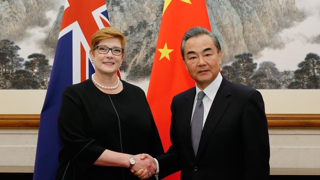 Foreign Minister Marise Payne shakes hands with her Chinese counterpart Wang Yi.