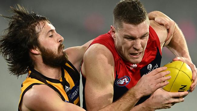 MELBOURNE, AUSTRALIA – JULY 17: Tom McDonald of the Demons is tackled by Tom Phillips of the Hawks during the round 18 AFL match between Melbourne Demons and Hawthorn Hawks at Melbourne Cricket Ground on July 17, 2021 in Melbourne, Australia. (Photo by Quinn Rooney/Getty Images)