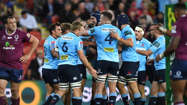 Waratahs players celebrate a try during their win over the Reds at Suncorp Stadium.