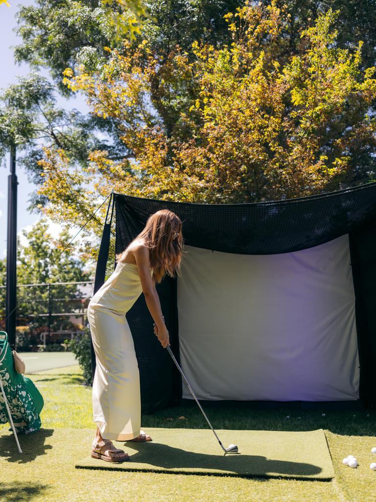 Rebecca Judd relaxed with a hit of golf at the party house. Picture: Supplied