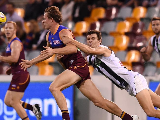 Adam Oxley puts in a tackle for the Pies.