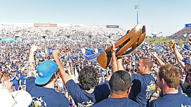 The North Queensland Cowboys bring the trophy home to 1300SMILES Stadium after their 2015 grand final win. For many supports, they hadn’t slept through the night and they weren’t letting daylight stop the party. Picture: Zak Simmonds