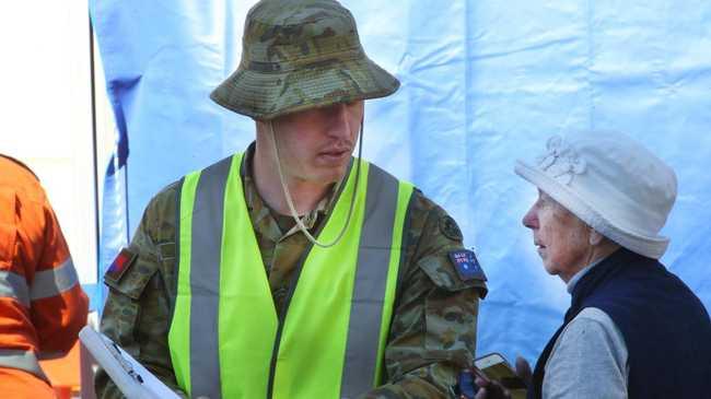 Pedestrian foot traffic is stopped and checked for border passes as Queensland steps up its tightened security with Covid restrictions. PHOTO: Scott Powick