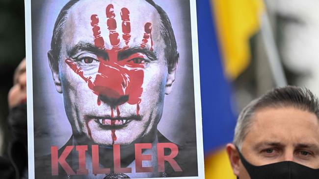 A demonstrator holds a sign depicting Russian President Vladimir Putin during a protest against Russia's invasion of Ukraine, in Madrid. Picture: Gabriel Bouys/AFP