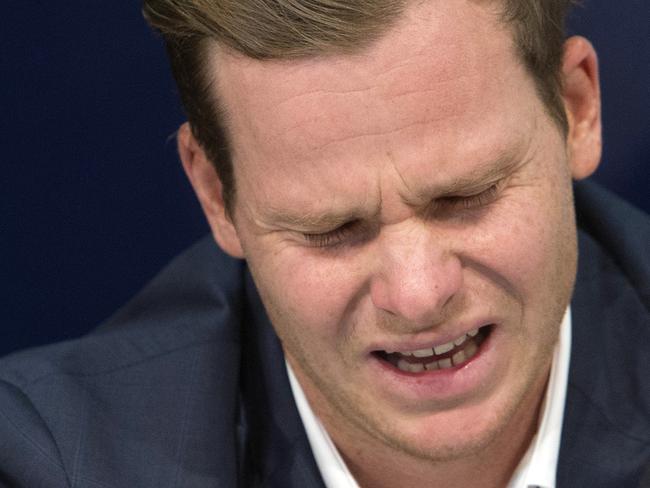 Former Australian cricket captain Steve Smith, left, speaks to the media while his father, Peter, hold his hand on his back in Sydney, Thursday, March 29, 2018, after being sent home from South Africa following a ball tampering scandal. Smith and vice-captain David Warner were banned for 12 months while young batsman Cameron Bancroft received 9 months after an investigation into the Australian cricket team's cheating scandal identified Warner as the instigator of the ball tampering plan that unraveled in South Africa. (AP Photo/Steve Christo)