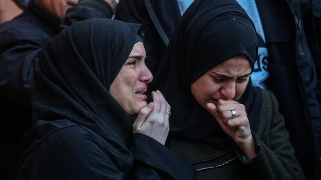 People mourn as they collect the bodies of Palestinians killed in an airstrike on December 2, 2023 in Khan Yunis, Gaza. Picture: AFP