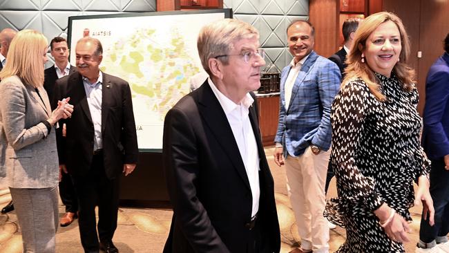 International Olympic Committee President Thomas Bach walks with Queensland Premier Annastacia Palaszczuk at the Sofitel Hotel in Sydney, with the Premier’s partner Reza Adib seen standing in the background. Picture: NCA NewsWire / Jeremy Piper