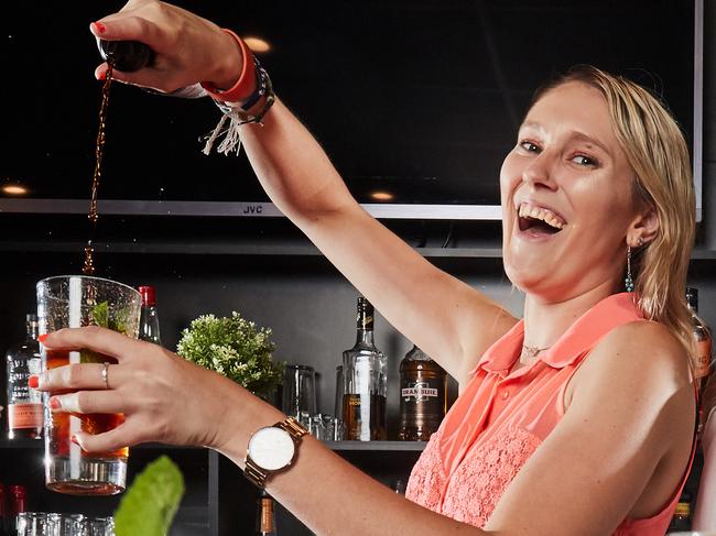 Bartenders Jasmine Hall and Amberlee Withers pose for a picture at the Crown Inn Hotel in Old Reynella, with their top cocktails, Friday, Dec. 8, 2017. (AAP Image/MATT LOXTON)