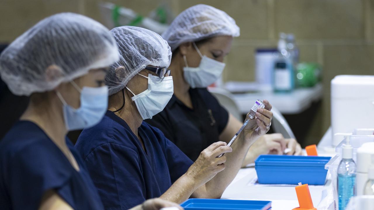 Nurses are seen drawing up doses from a vile of AstraZeneca COVID-19 vaccine in Perth. Picture: Matt Jelonek/Getty Images