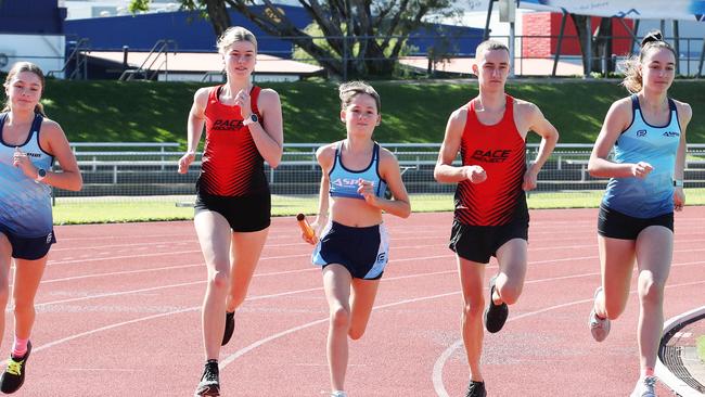 ON YOUR MARKS: Grace Campbell, 10, Jorja Catelan, 14, Toby Gillen 19, Eryn Vicary, 17, and Lili Boyd, 18, will all participate in the 400m relays held over 105 laps at Barlow Park this afternoon in an attempt to better Eliud Kipchoge’s marathon world record. Picture: BRENDAN RADKE.