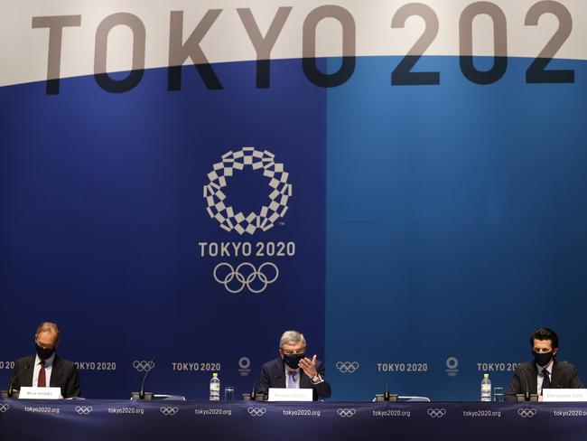 IOC President Thomas Bach (C), IOC Olympic Games Executive Director Christophe Dubi and IOC spokesman Mark Adams (L) attend the press conference after the IOC Executive Board meeting on July 17. (Photo by Toru Hanai/Getty Images)