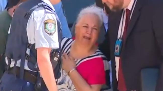 A woman, believed to be Albert’s wife, is inconsolable at the scene of the stabbing. Picture: 7 News