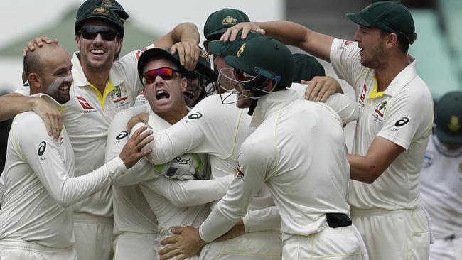 David Warner continues to bark at de Villiers as he is swamped by teammates. Picture: AP