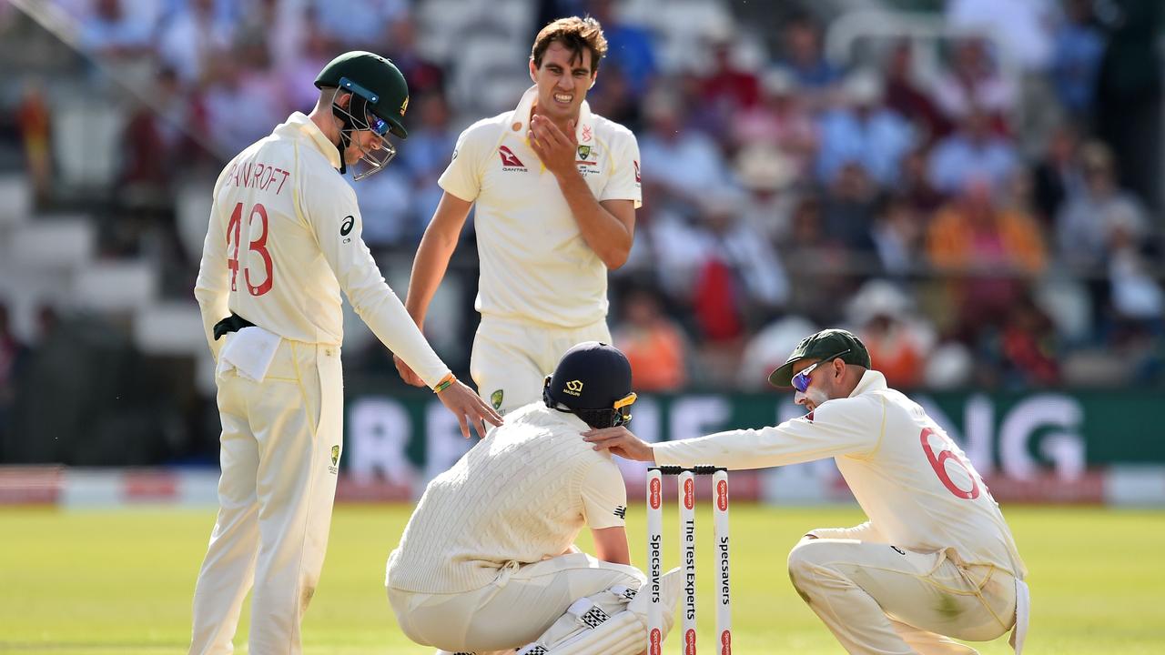 Chris Woakes was struck on the head by a vicious bouncer from Pat Cummins.