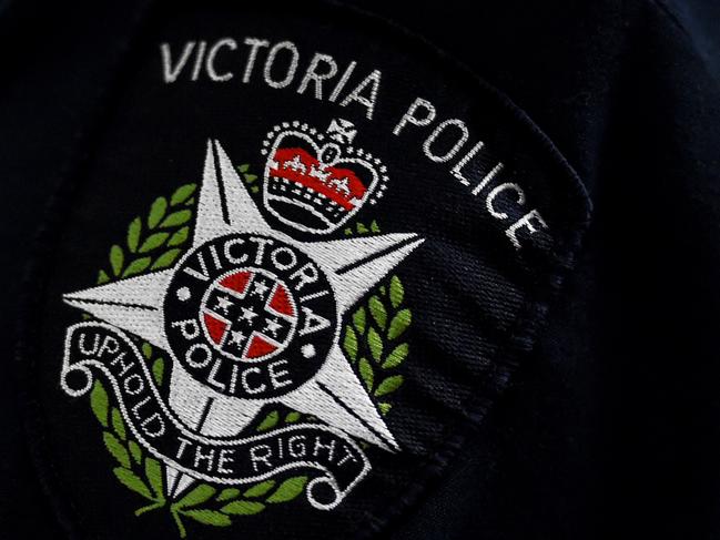 A Victorian Police badge is seen as approximately 275 kilograms of crystal methamphetamine is displayed at the Australian Federal Police offices in Melbourne, Monday, July, 4, 2016. A Victoria Joint Organised Crime Task Force (JOCTF) seized the methamphetamine with a street value of $275 million after identifying the syndicate in February, arresting one Malaysian and seven Australians. This is the biggest seizure in Victoria this year. (AAP Image/Tracey Nearmy) NO ARCHIVING