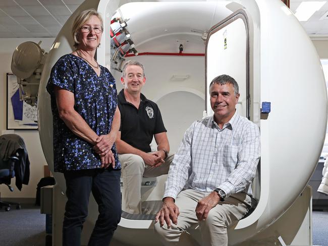 Clinical nurse Bebe Brown, hyperbaric facility manager Corry Van Den Broek and co-clinical director Dr. David Smart sitting in the old hyperbaric chamber at the Royal Hobart Hospital. Picture: LUKE BOWDEN