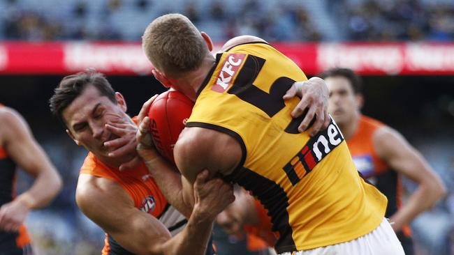 MELBOURNE, AUSTRALIA – JUNE 27: James Worpel of the Hawks fends Isaac Cumming of the Giants off illegally during the round 15 AFL match between the Greater Western Sydney Giants and the Hawthorn Hawks at Melbourne Cricket Ground on June 27, 2021 in Melbourne, Australia. (Photo by Daniel Pockett/Getty Images)