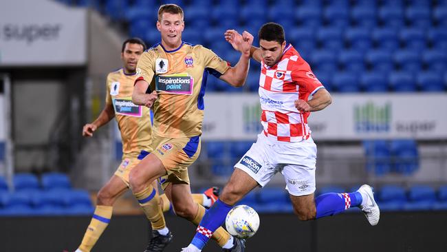 Newcastle’s Lachlan Jackson and Gold Coast Knights’ Jarrod Kyle do battle in the FFA Cup on Tuesday night. Picture: AAP Image/Dave Hunt.