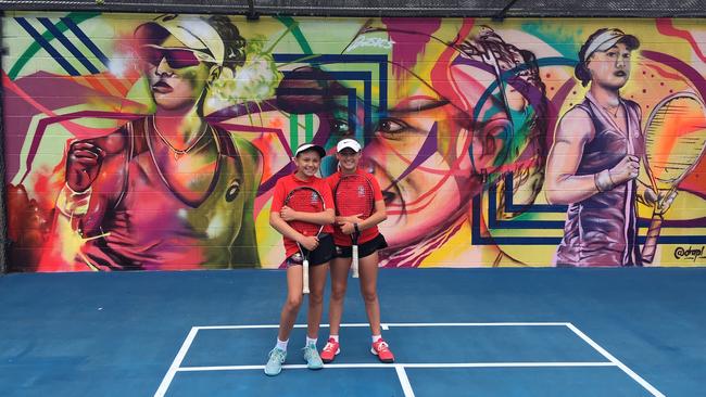 Kelvin Grove State High School tennis players Nicola Schoeman, left and Ella Pittendreigh at the unveiling of murals for Sam Stosur and Ashleigh Barty.