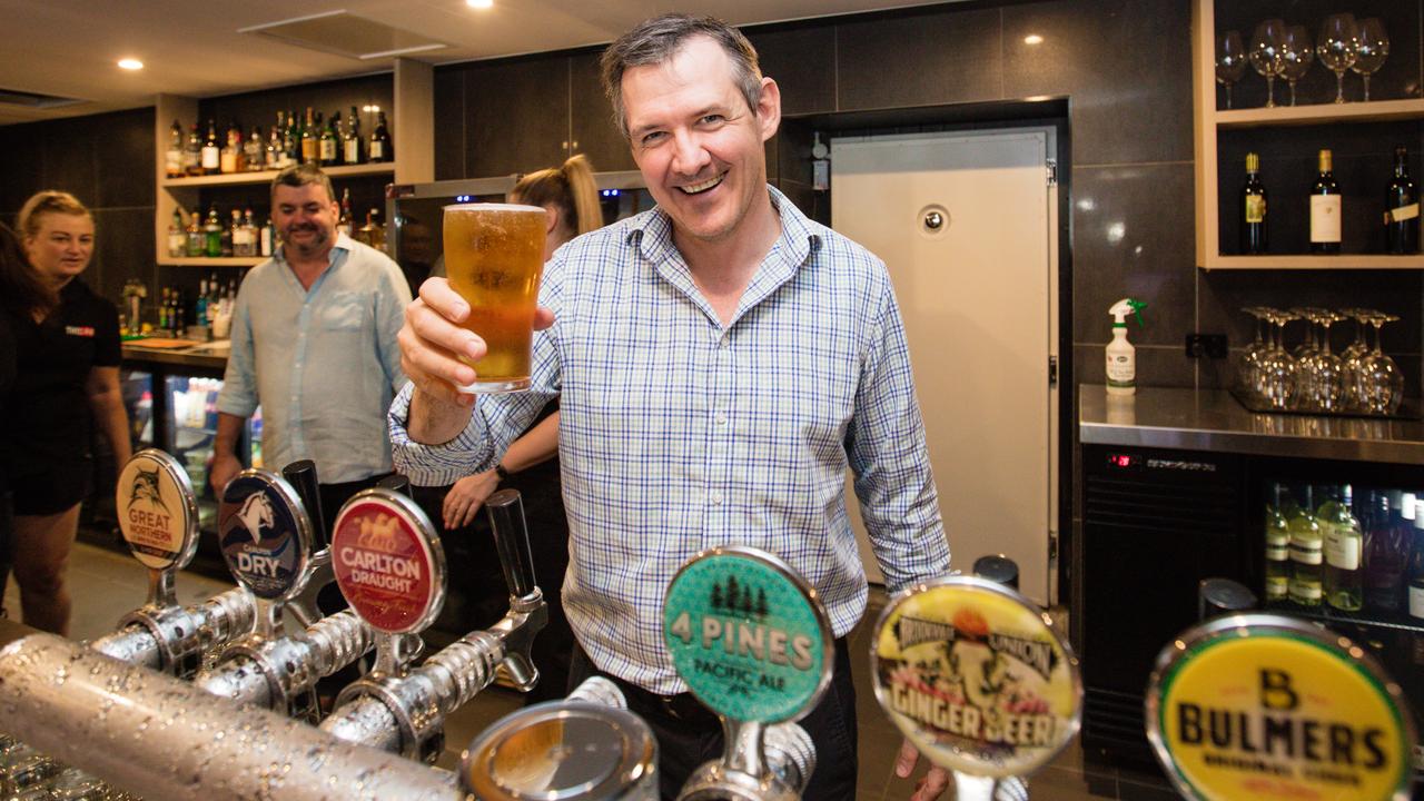 Chief Minister Michael Gunner pours a schooner with owner Paul Palmer at The Cavenagh Hotel. Picture GLENN CAMPBELL