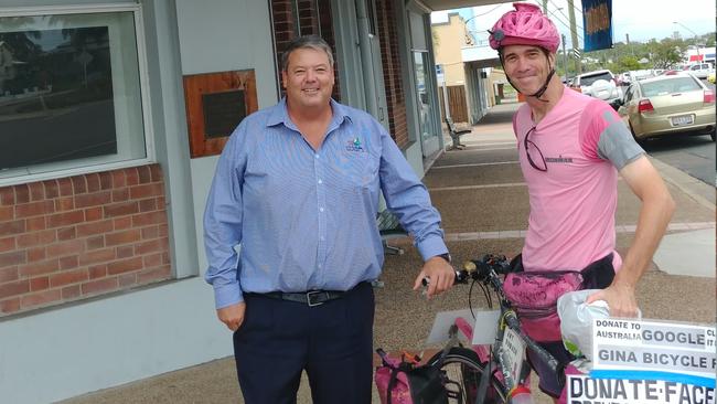 Whitsunday Regional Council Mayor Andrew Willcox with Brent Bundy, who is riding from Sydney to Cairns and back to raise funds for the Cancer Council. Photo: Contributed